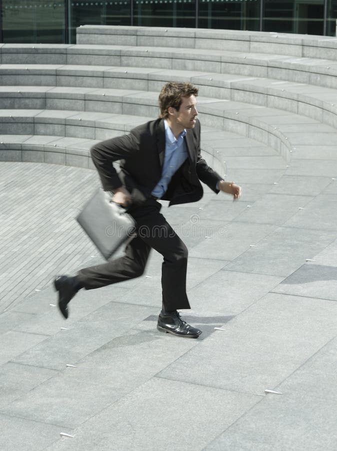Businessman With Briefcase Running Upstairs