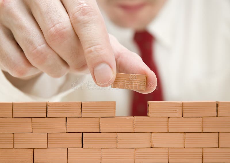 Businessman building a wall