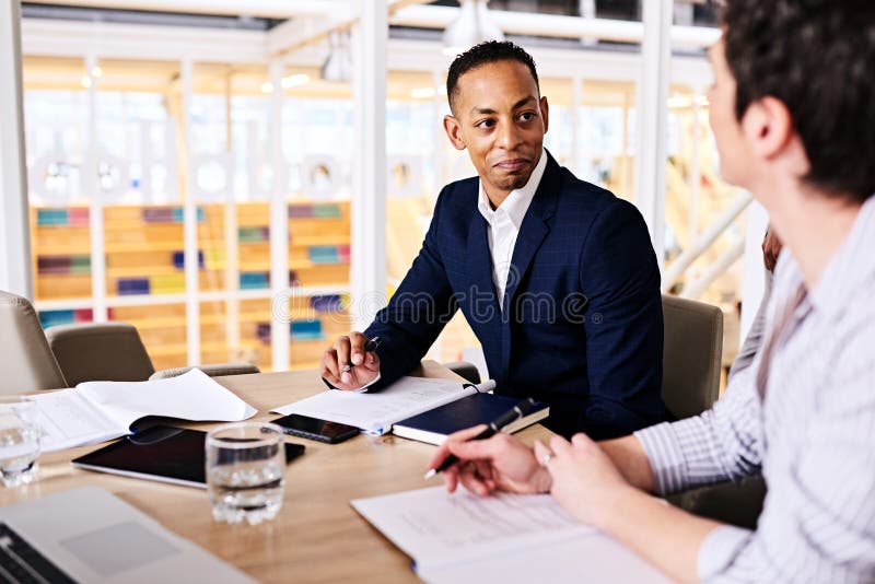 Businessman and businesswoman dicussing collaborative business in board room stock photography Businessman and businesswoman dicussing collaborative business in board room stock photography