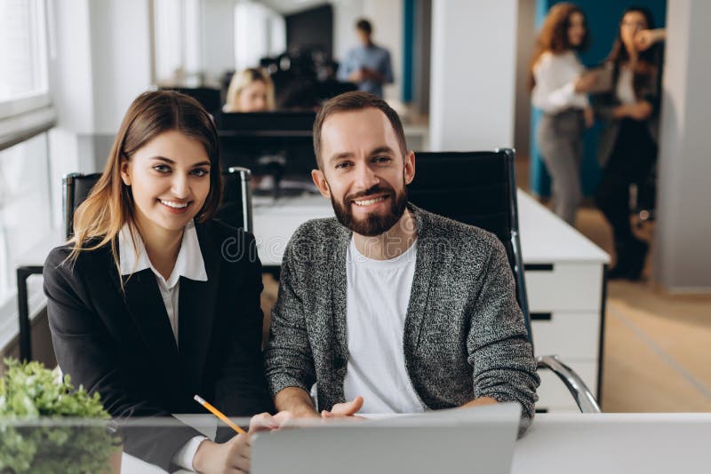 Businessman and businesswoman working with laptop at modern office royalty free stock image Businessman and businesswoman working with laptop at modern office royalty free stock image