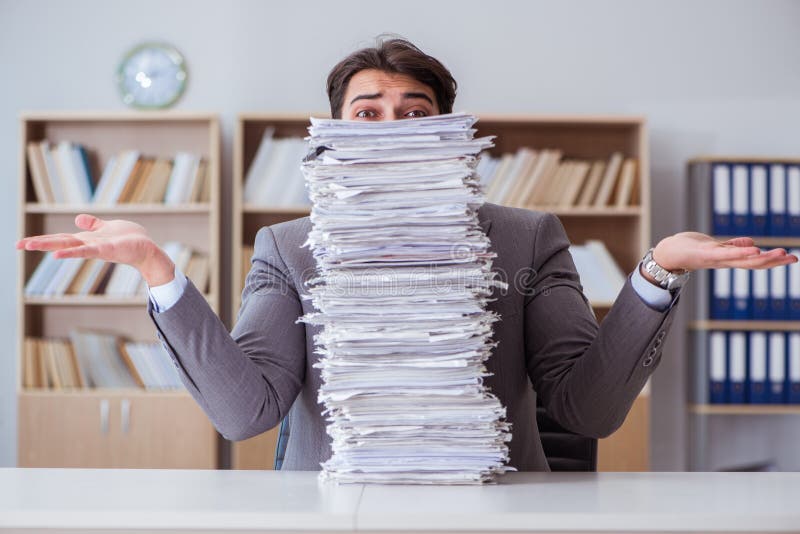 The businessman busy with paperwork in office