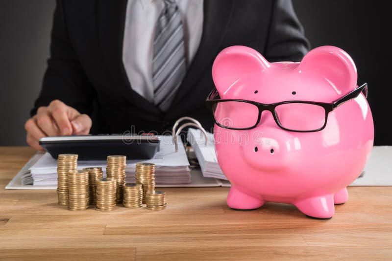 Businessman Calculating Tax On Desk royalty free stock image Businessman Calculating Tax On Desk royalty free stock image