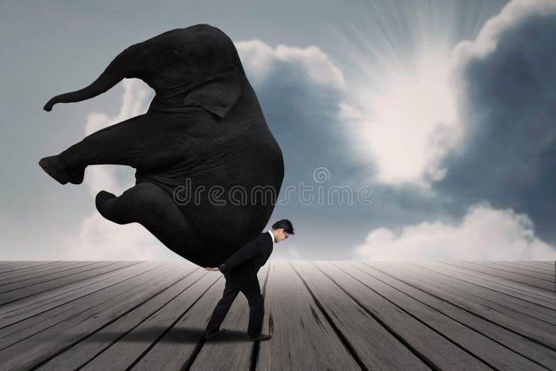 Businessman carry elephant by himself under blue sky