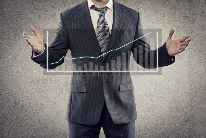 Businessman with chart. Portrait of young businessman showing flow chart of economic growth on the screen. Male entrepreneur with financial diagram posing in stock image Businessman with chart. Portrait of young businessman showing flow chart of economic growth on the screen. Male entrepreneur with financial diagram posing in stock image