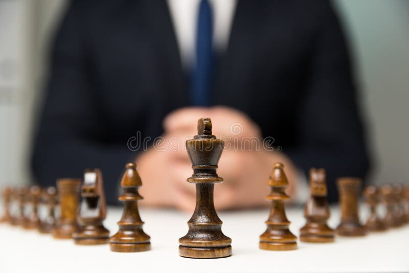 Two King chess pieces on a chessboard with the light king lying on its side  at the foot of the victorious dark wood King Stock Photo - Alamy