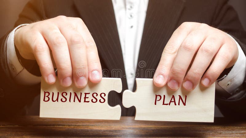 Businessman collects puzzles with the word Business Plan. Business operations program. Organization and management of processes stock photography Businessman collects puzzles with the word Business Plan. Business operations program. Organization and management of processes stock photography