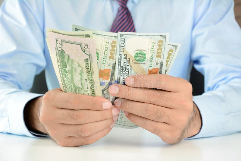 Businessman counting money,US dollar (USD) banknotes