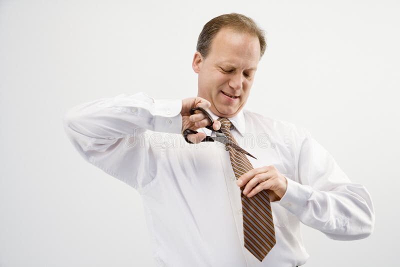 Businessman cutting necktie royalty free stock photography Businessman cutting necktie royalty free stock photography