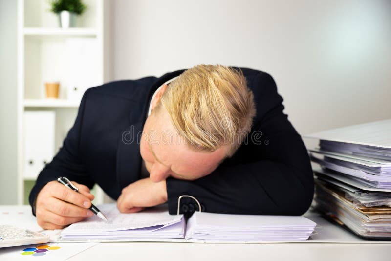 Businessman in a dark blue suit calculating sales results. Finance accounting concept stock photography Businessman in a dark blue suit calculating sales results. Finance accounting concept stock photography