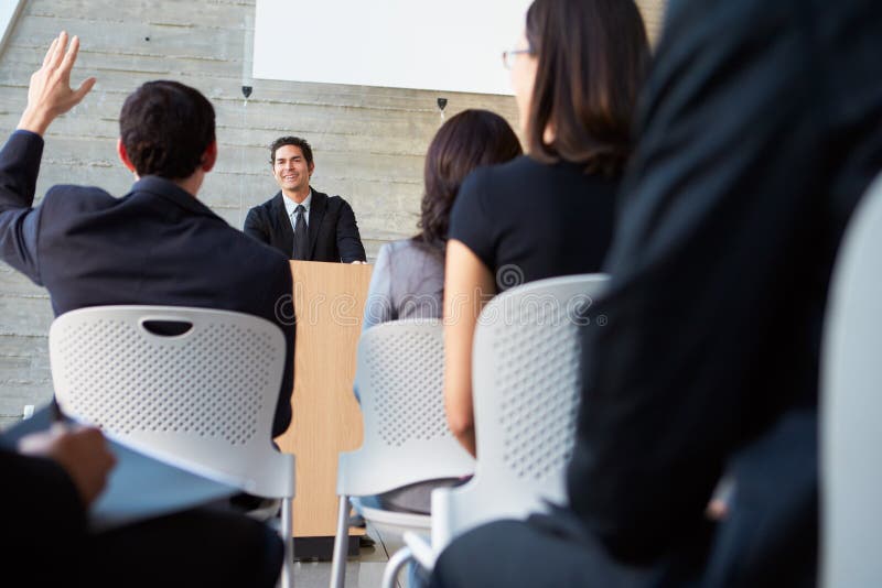 Businessman Delivering Presentation At Conference Smiling. Smiling asking stock images, royalty-free photos and pictures