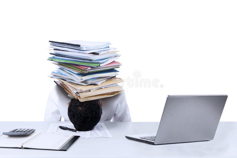 Depressed young businessman with a pile of documents on his head at office. Depressed young businessman with a pile of documents on his head at office