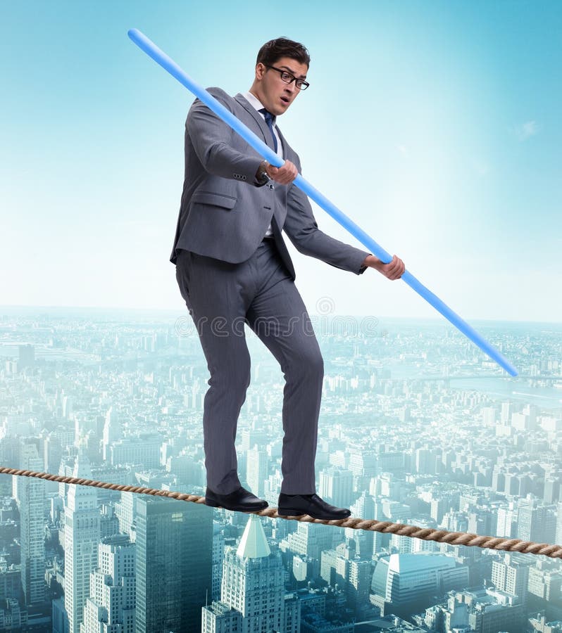 Businessman doing tightrope walking in risk concept