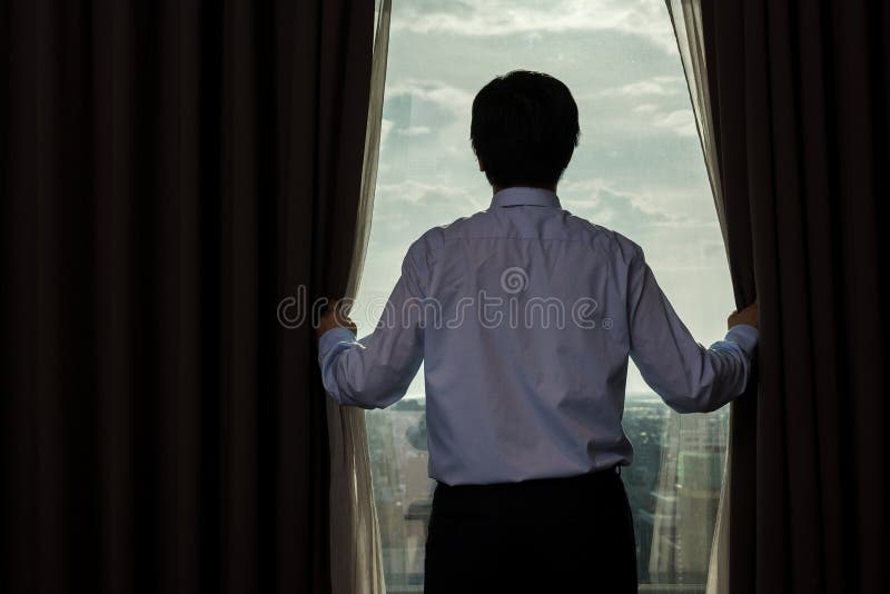 Businessman draw the curtain