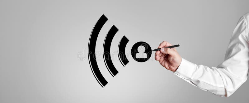 Businessman draws wifi icon on gray background royalty free stock image