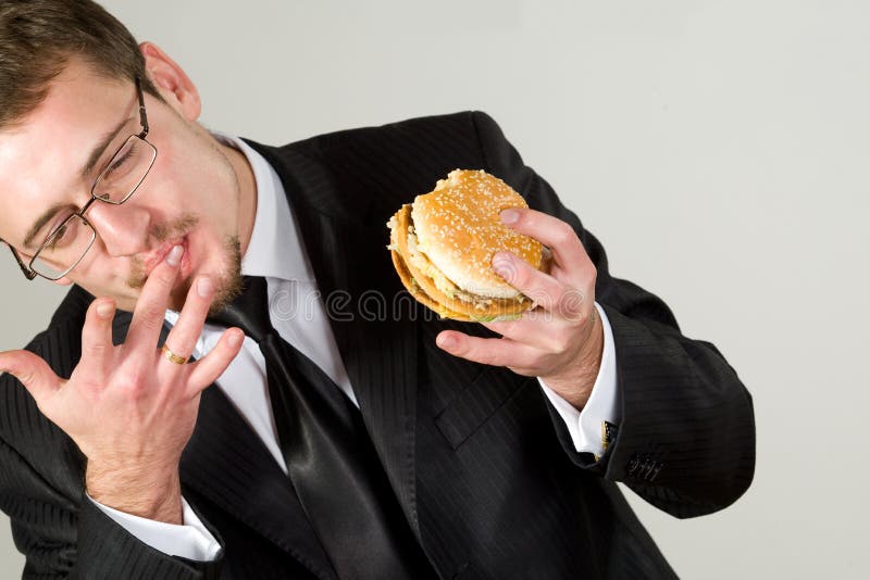 Businessman eating hamburger