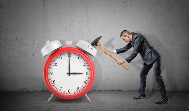 A businessman fails to smash a large red alarm clock because his hammer breaks. royalty free stock photography A businessman fails to smash a large red alarm clock because his hammer breaks. royalty free stock photography