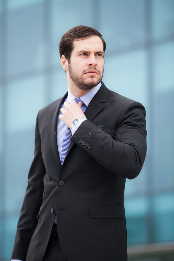Businessman fixing his tie stock images Businessman fixing his tie stock images