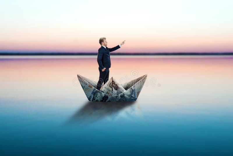 A businessman floats in a Paper Boat made of dollars banknotes. Origami from money, financial business model, the path to success