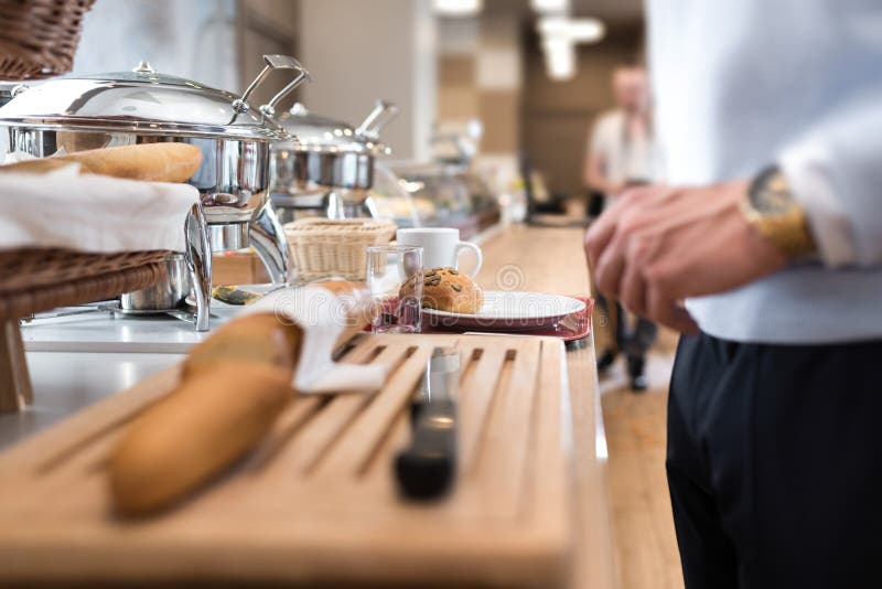 Businessman in front of the hotel buffet taking a breakfast