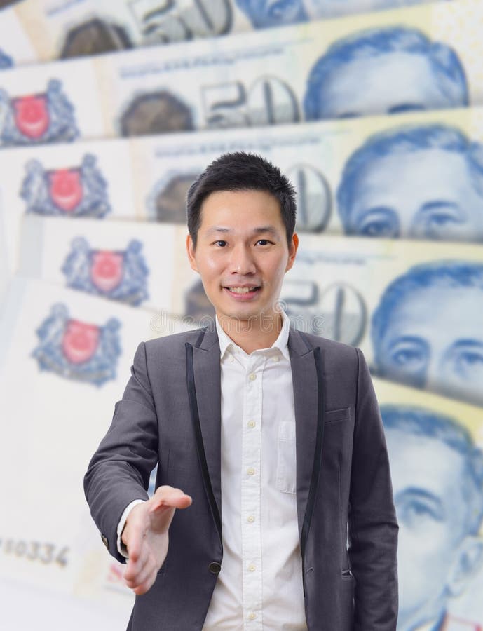 Businessman gives a handshake with Singapore dollar banknote background royalty free stock images Businessman gives a handshake with Singapore dollar banknote background royalty free stock images