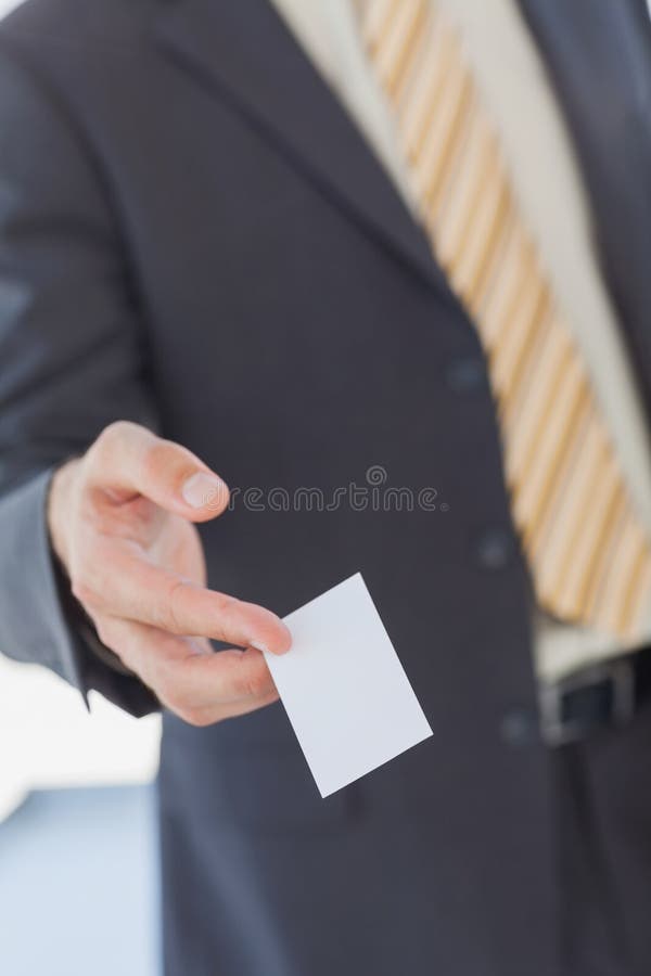 Businessman giving a white blank business card royalty free stock photos Businessman giving a white blank business card royalty free stock photos