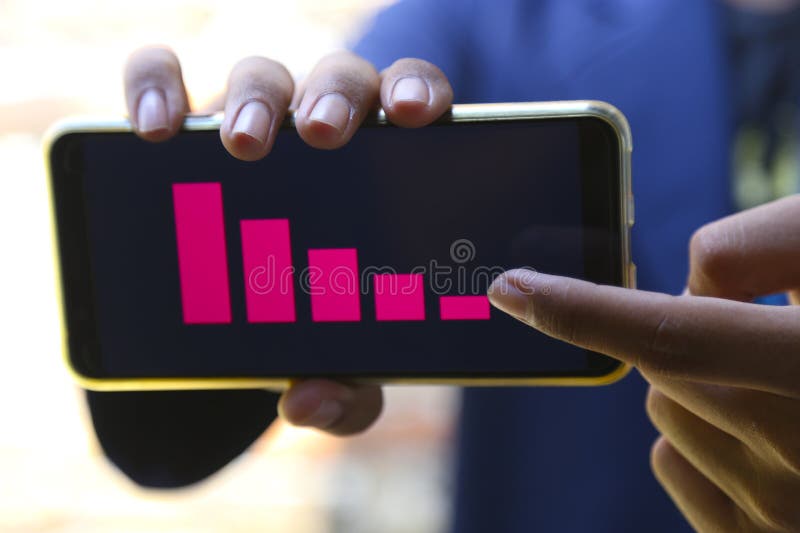 Businessman han showing decrease graph on smartphone stock photo