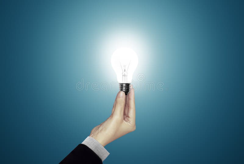 Man Holding Lamp Bulb Over Table Stock Photo Image of concept