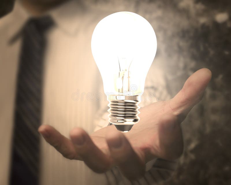 Businessman hand holding lightbulb with bright light