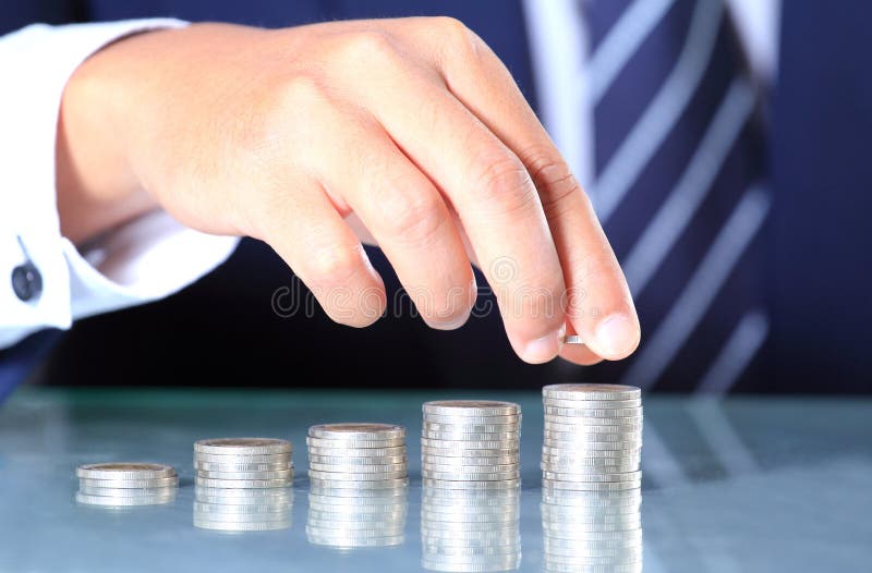 Businessman hand put coins