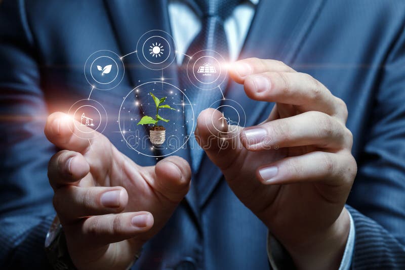 Businessman hands interact with alternative energy sources on blurred background stock images