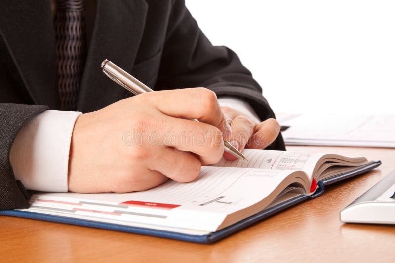 Businessman hands writing in organizer stock photo