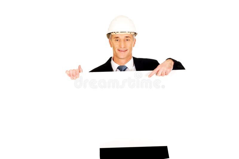 Businessman with hard hat holding empty banner