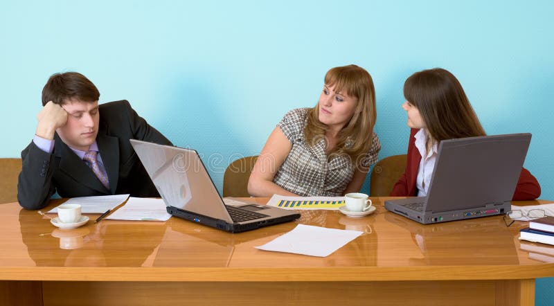 Young businessman has fallen asleep sitting at meeting