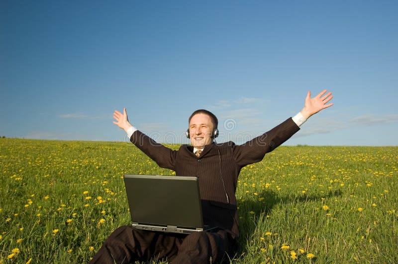 Businessman with headset and laptop outdoor