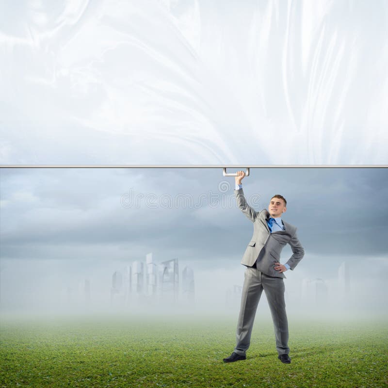 Businessman holding a banner with one hand stock photography