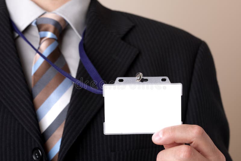 Businessman holding blank ID badge