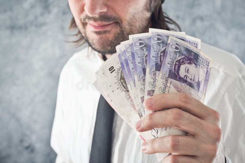 Businessman holding British pounds money stock image Businessman holding British pounds money stock image
