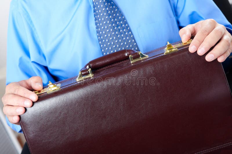 Businessman holding a brown case