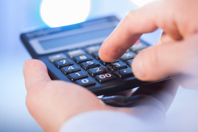 Businessman Holding a Calculator and Counting Stock Photo Image of