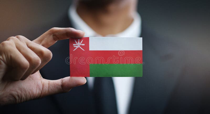 Businessman Holding Card Oman Flag royalty free stock image
