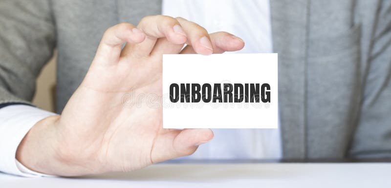 Businessman holding a card with text ONBOARDING. Business concept stock photos