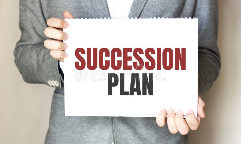 Businessman holding a card with text SUCCESSION PLAN stock images