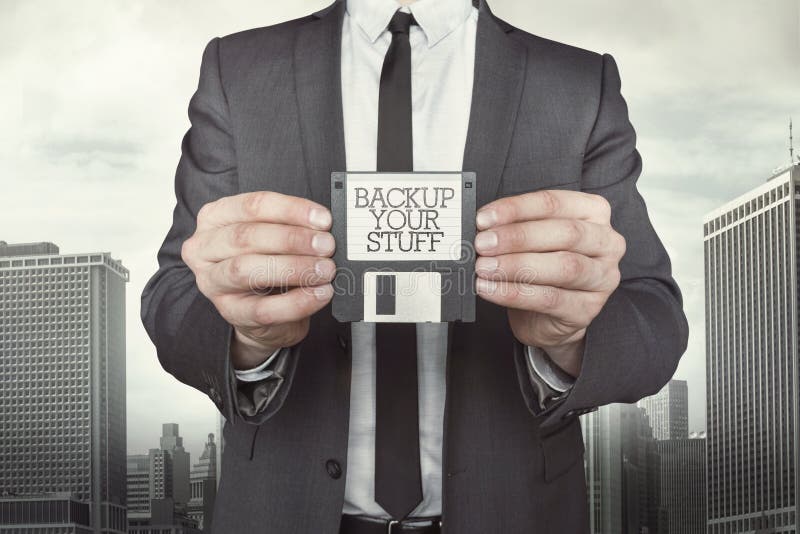 Businessman holding diskette in hands stock photo Businessman holding diskette in hands stock photo