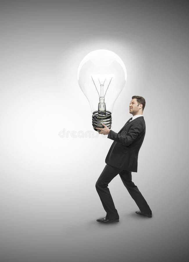 Businessman holding lamp stock photo. Image of teaching 32874946
