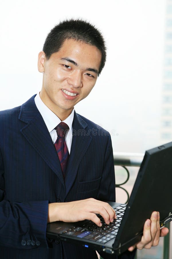 Businessman holding laptop computer