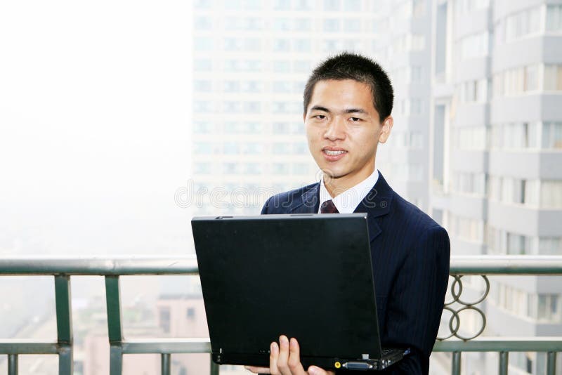 Businessman holding laptop computer