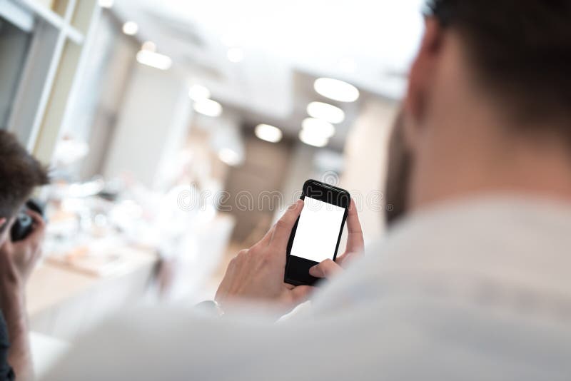 Businessman holding mobile phone in his hand stock images