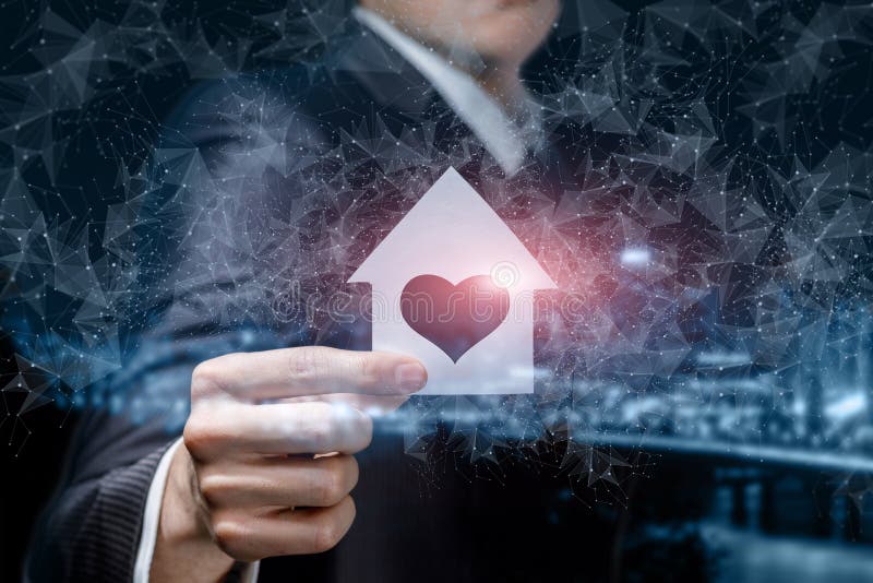Businessman holding model house with heart inside royalty free stock image