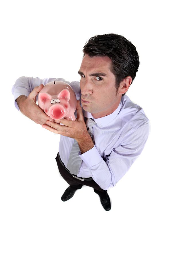 Businessman holding piggy-bank royalty free stock photos