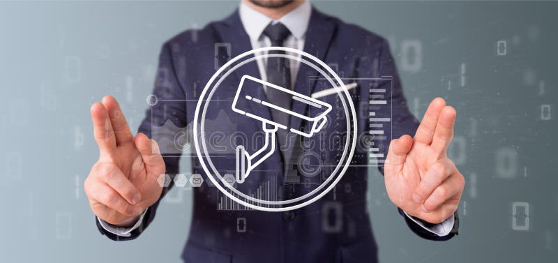 Businessman holding Security camera system icon and statistics d
